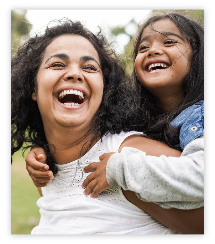 Mother and daughter laughing together.